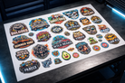 DTF gang sheet with colorful full-color designs printed on white PET film